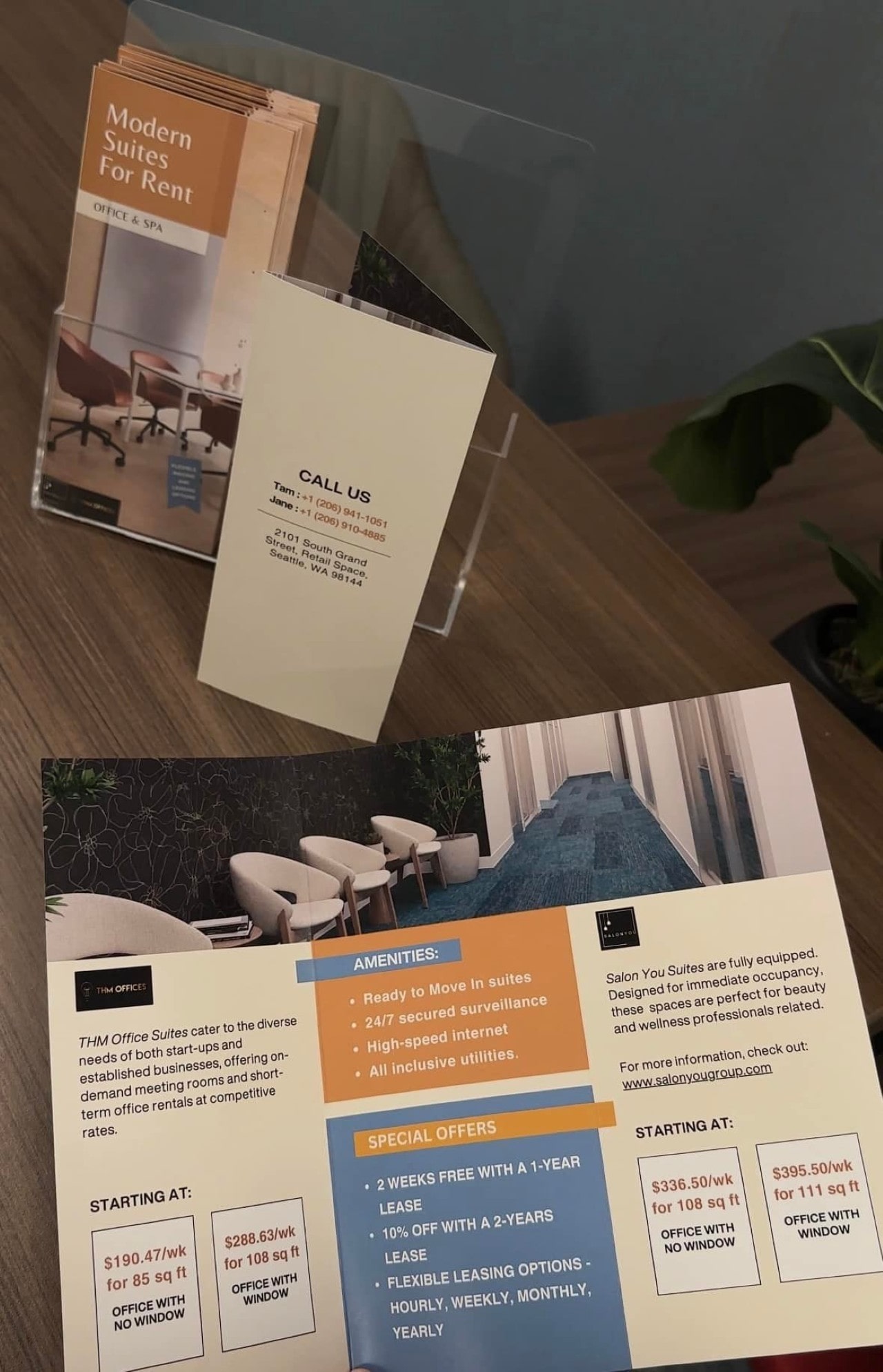 A close-up of promotional flyers for Salon You Suites detailing weekly rental prices, special offers, and amenities.